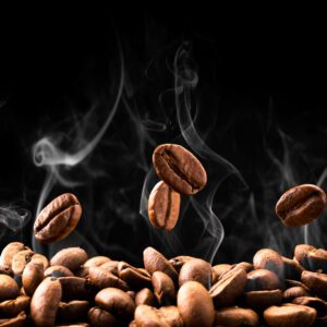 A pile of coffee beans with smoke coming out.