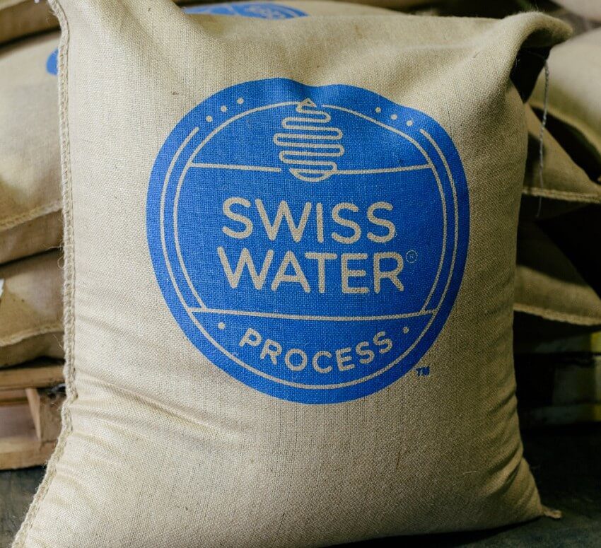 A bag of swiss water process is sitting on the floor.